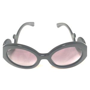 Black, oversized Sunglasses by Prada.